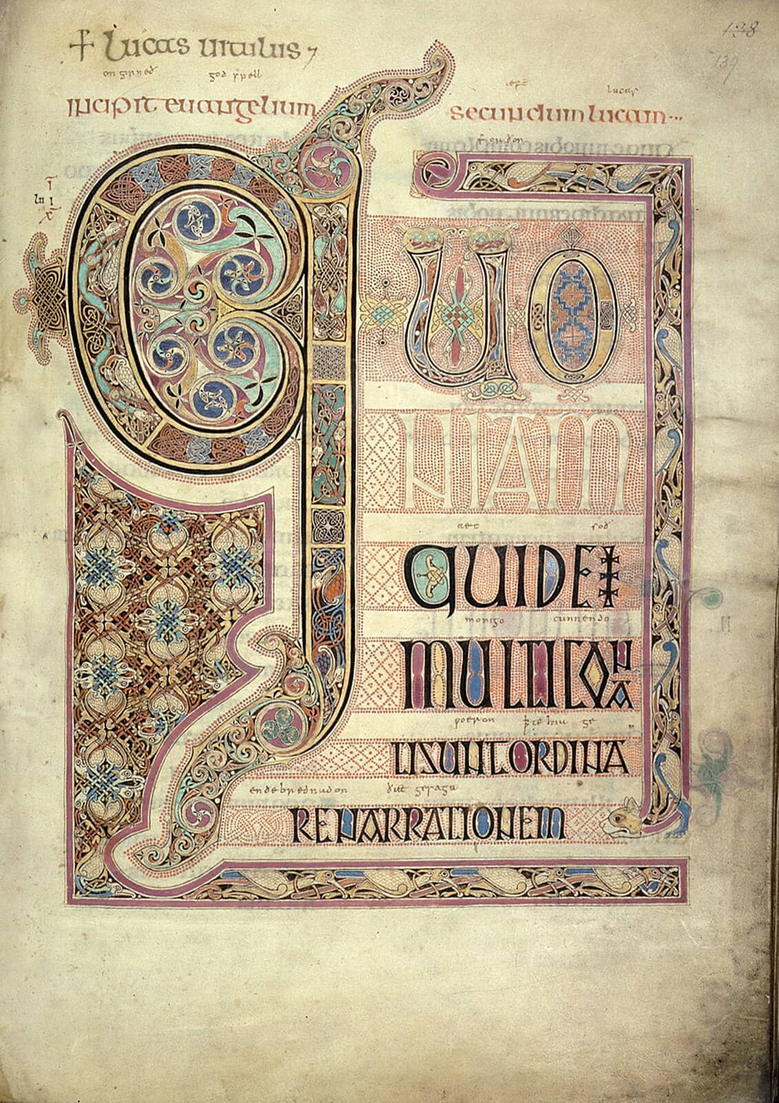 The opening page of Saint Luke's Gospel in the Lindisfarne Gospels: its first words painted in huge letters filled with knotwork and spirals in red, blue, gold and green.